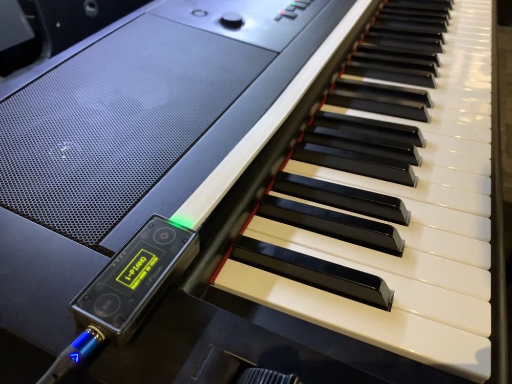 iPiano control unit mounted on a keyboard, OLED display lit